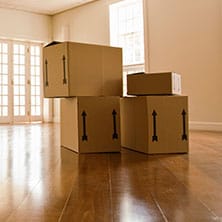 moving boxes on an empty living room floor